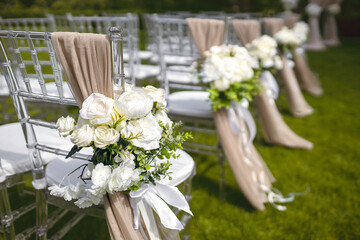Wedding decor in the form of flowers on the chairs of the guests for the wedding ceremony....