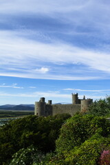 Fototapeta na wymiar Harlech Castle, Wales. Landscape view of a historic UNESCO monument. Beautiful Welsh world heritage site. Fortification of Edward 1 of England. Blue sky and copy space.