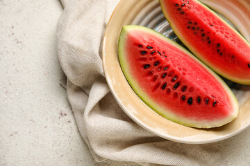 Plate with slices of watermelon and napkin on white background