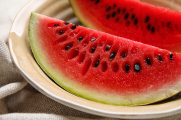 Plate with slices of watermelon and napkin on white background, closeup