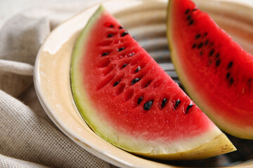 Plate with slices of watermelon and napkin on white background, closeup