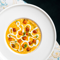 Risotto with pumpkin kimchi and gorgonzola cheese on the table, copy space. food concept