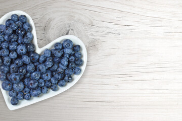 Heart Health Concept - Fresh Blueberries on Heart Shaped Plate with Copy Space
