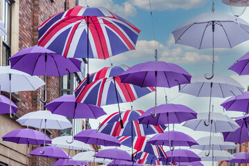 Fototapeta na wymiar Street adorned with umbrellas with the flag of the United Kingdom.