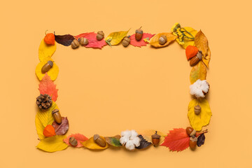 Frame made of natural forest decor and cotton flowers on color background