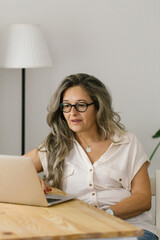 Portrait of adult woman working from home, businesswoman working at home office  