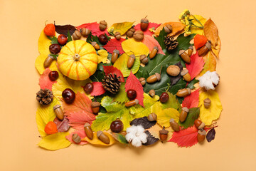 Naklejka premium Autumn forest decor, cotton flowers and pumpkin on color background