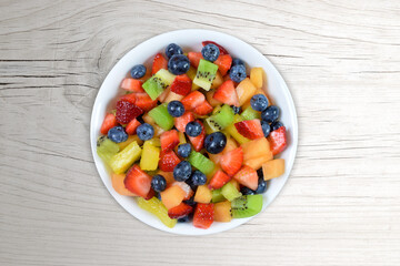 Fresh Cut Fruit Salad on a White Wood Background
