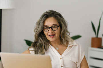 Portrait of adult woman working from home, businesswoman working at home office  