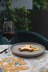 Beef tartare with mushrooms, truffle and capers on a plate. Serving in the restaurant