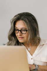 Portrait of mature woman working on laptop