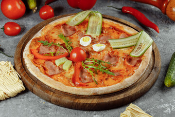 Children's pizza in the shape of a cat's face on a white plate, on a white background, top view. Children's menu