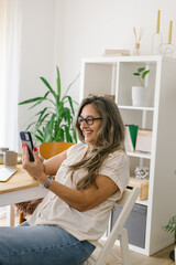 Obraz na płótnie Canvas Lifestyle portrait of a businesswoman at home having a video call 