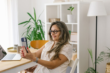 Lifestyle portrait of a businesswoman at home having a video call 