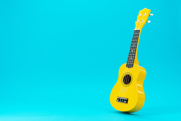 Perspective photo of ukulele with copy space. Yellow colored wooden ukulele guitar on the turquoise...