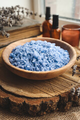 Plate with purple bath salt with candles on a old wooden table