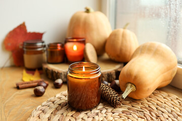 Thanksgiving autumn decor, burning candle, pumpkins and candles