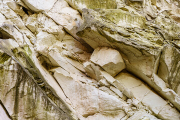 Texture cracked rock formation rock in the wild. Background with copy space