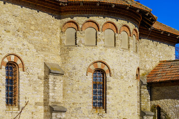 Fototapeta premium Windows of an ancient stone building of classical architecture. Background with selective focus and copy space