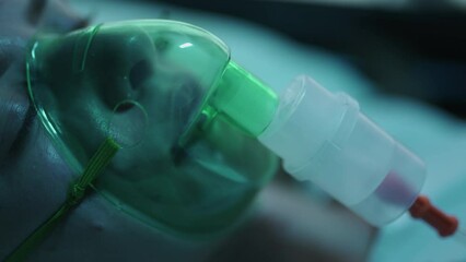 A female patient in medical mask is breathing oxygen support in a hospital with ecg heart rate machine. Unhealthy woman in coma. Getting mechanical ventilation. Concept of pandemic and therapy - Powered by Adobe