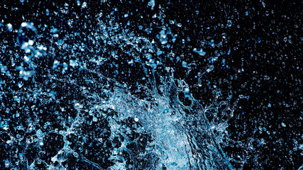 Wild water drops against a black background