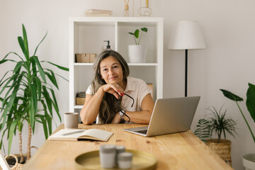 Female freelancer sitting and looking at the camera