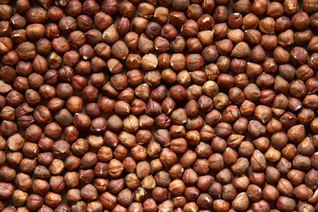 Shelled hazelnuts photographed from above. The image can be used as a background or to add text.