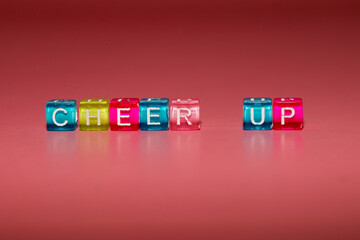 the word "cheer up" made up of cubes	