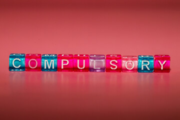 the word "compulsory" made up of cubes