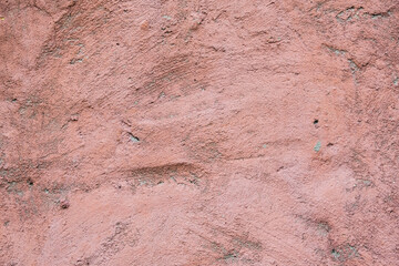 Dusty pink rose texture of concrete. An old concrete wall painted with pink paint. Rose concrete background.