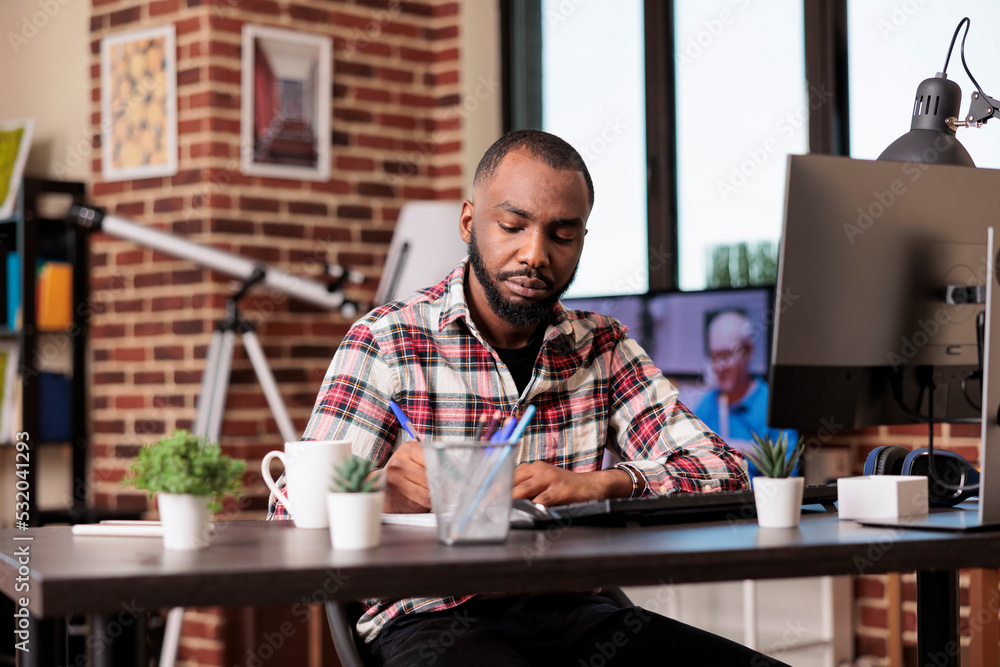 Poster company freelancer taking notes on files, writing report information on notebook at office desk. wor