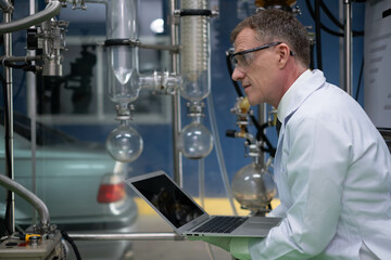 scientist in lab coat, researcher working in laboratory with cannabis oil CBD extraction machine, Chemical lab test on cannabis oil, CBD, THC, alternative medical. extract chemicals from cannabis.