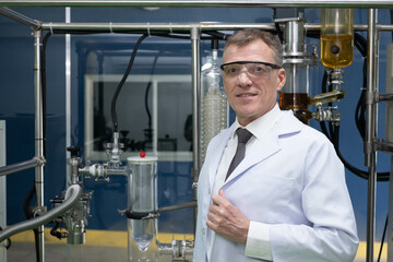 scientist in lab coat, researcher working in laboratory with cannabis oil CBD extraction machine, Chemical lab test on cannabis oil, CBD, THC, alternative medical. extract chemicals from cannabis.