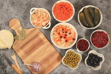 Fermented products on a concrete table, food background, advertising banner, healthy food concept, sauerkraut, kimchi, pickled beets, cucumbers, peas, olives, natural products for weight loss,