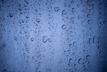 background of a light gray iron shiny sheet of iron, after the rain with dew drops, after the rain, the texture of water drops on a steel sheet with a shadow, mirror surface, mirror, blue background