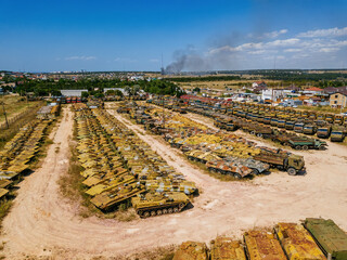 Old rusty broken Russian military vehicles in industrial area, aerial view