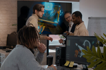 Caucasian male artist designer with dreadlocks and glasses draws on a tablet a 3D model for a...