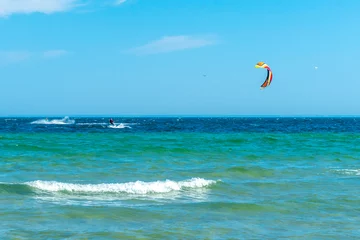 Foto op Plexiglas Kite surfer in the distance on turquoise waters of Baltic sea. Hel, Poland, Europe. Sport and recreation by the sea. Summer holiday. © Petr