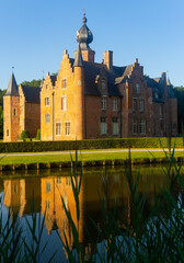 Reflection of Rumbeke Castle in water on summer day located in Rumbeke in West Flanders, Belgium