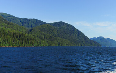 BC seascape in summer with gently rippling waves and mountainous coastline.