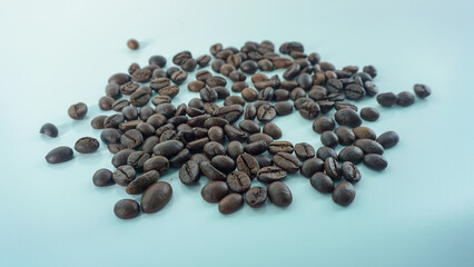 Selective focus concept. Roasted coffee beans on white background.