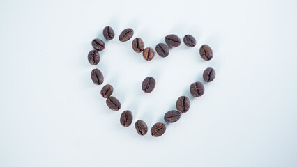 Coffee beans in shape of heart isolated on white background