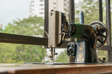 sewing machine with tread and needle in vintage mechanical steampunk machine