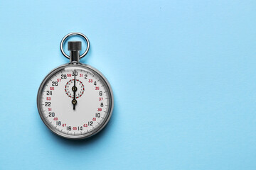 Vintage timer on light blue background, top view. Space for text