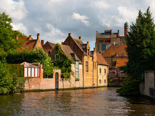 Fototapeta na wymiar Picturesque summer landscape with views of houses and canals in the small town of Brugge, Belgium
