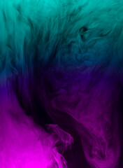 Fototapeta na wymiar swirling clouds of purple and turquoise smoke randomly mix on a black background