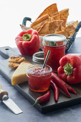An arrangement of hot pepper jelly with cracker bread and cheese.