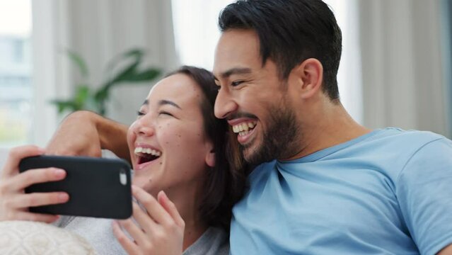 Social media, phone and funny couple live streaming, vlogging and recording a video online together at home. Happiness, content creator and happy boyfriend laughing after a prank on a young woman