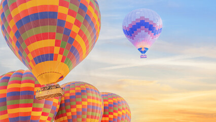 Fototapeta na wymiar multi color hot air balloon flying over sunrise sky
