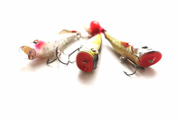 Set of fishing lures with a triple hook, poppers